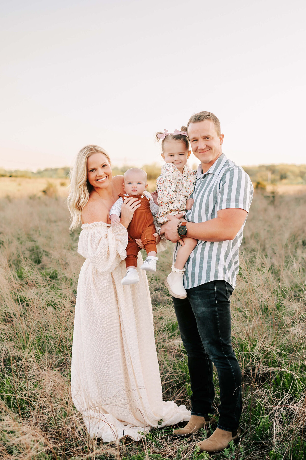 family standing in field at sunset during Springfield Mo family photography session