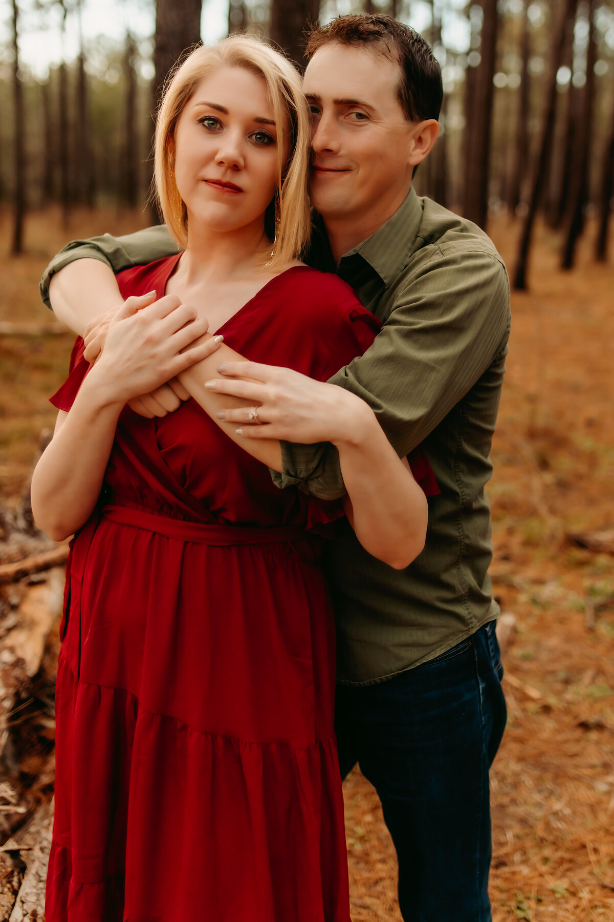 Couples portrait in Kingwood, Texas with partners holding each other in the woods