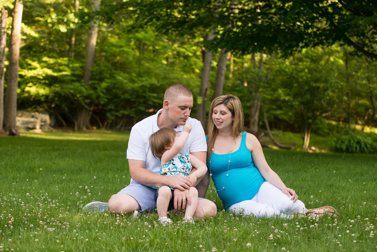 family maternity photos outside in field