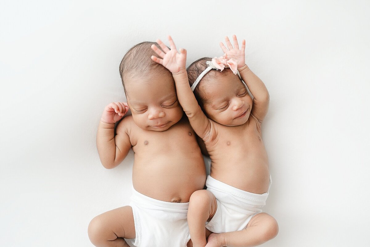 A gallery wall of framed newborn portraits.