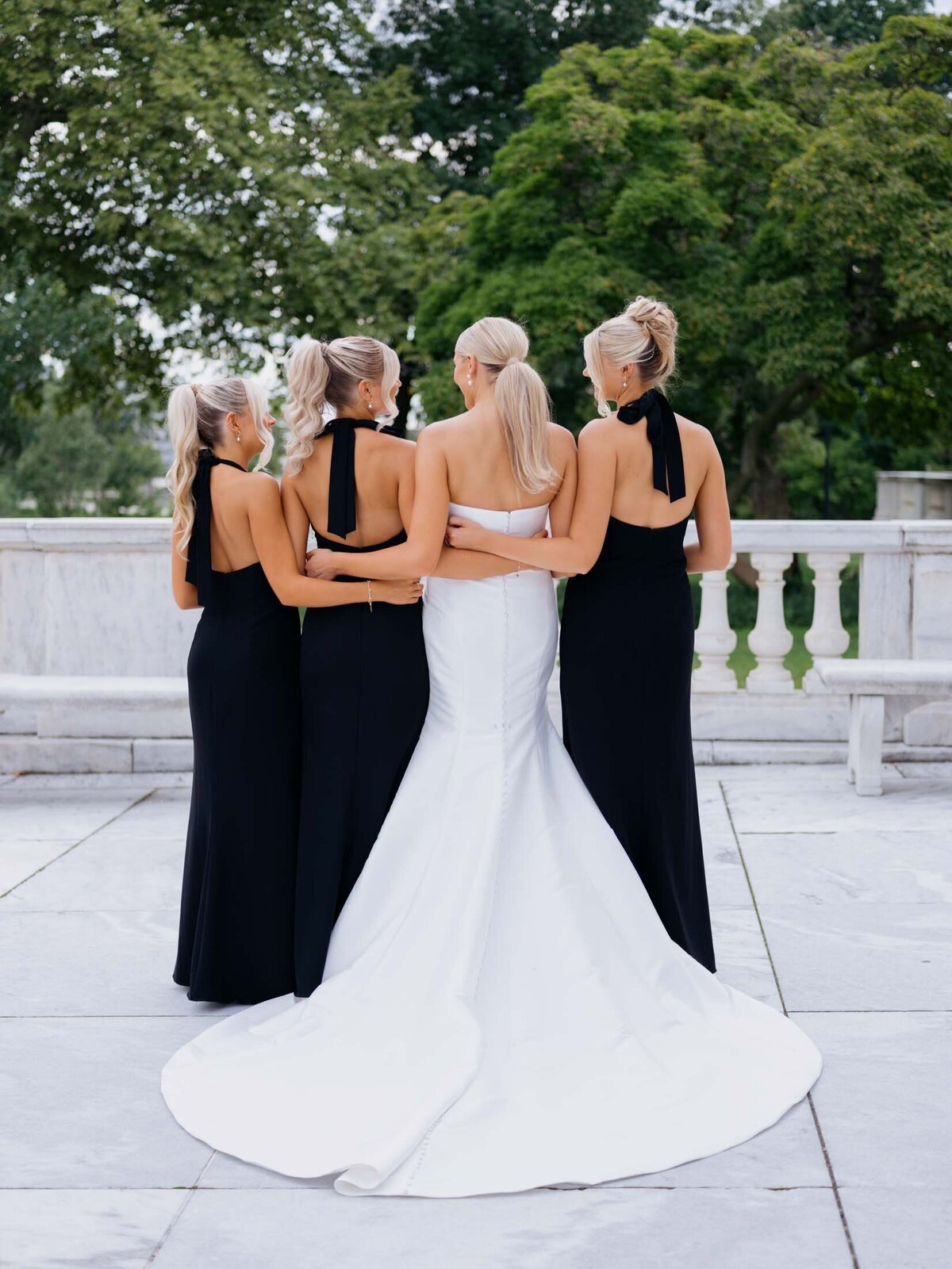 Bride with bridesmaids in black dresses at Cleveland Art Museum