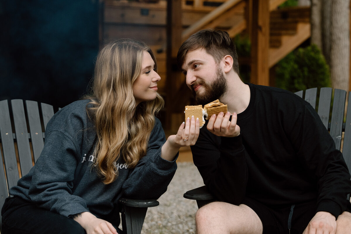 Couple toasting s'mores.