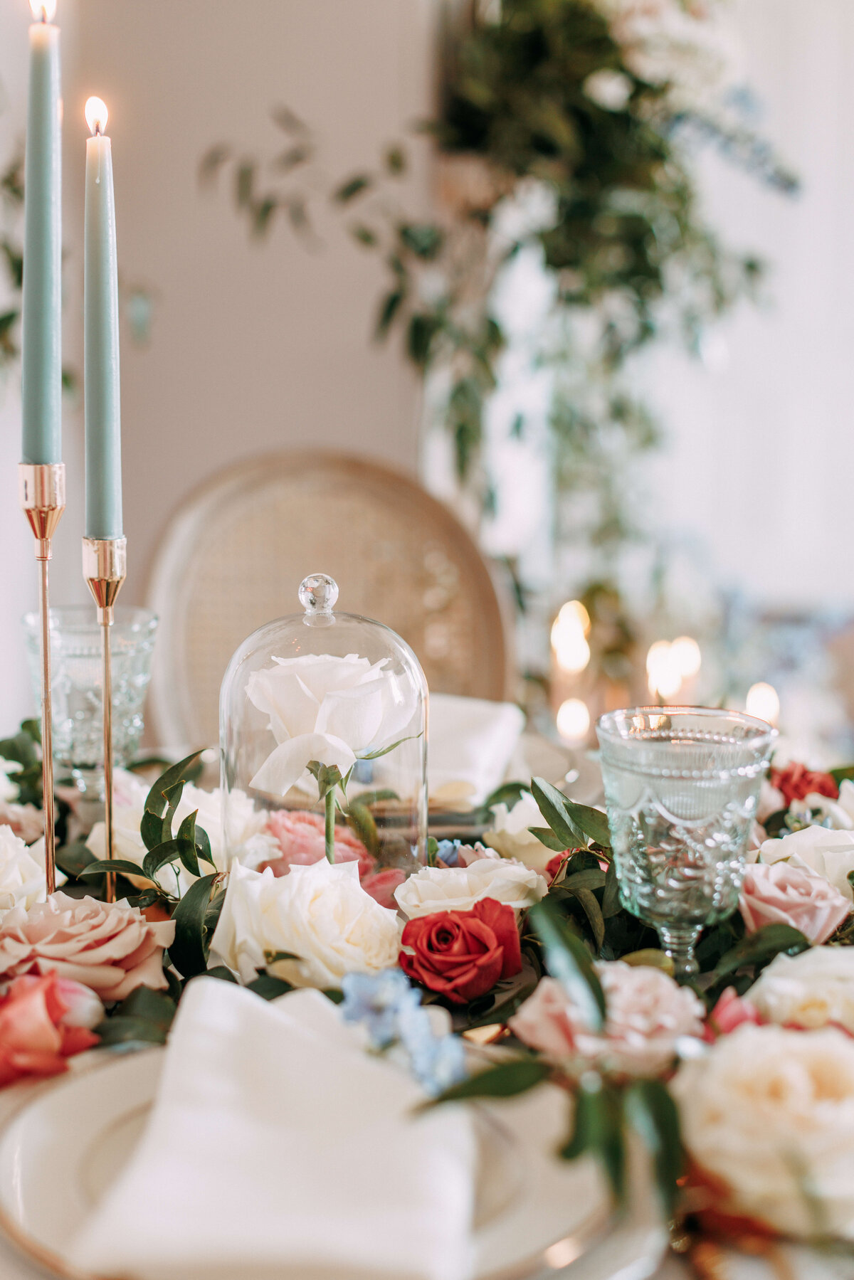 tablescape with blue tinted glasses and florals