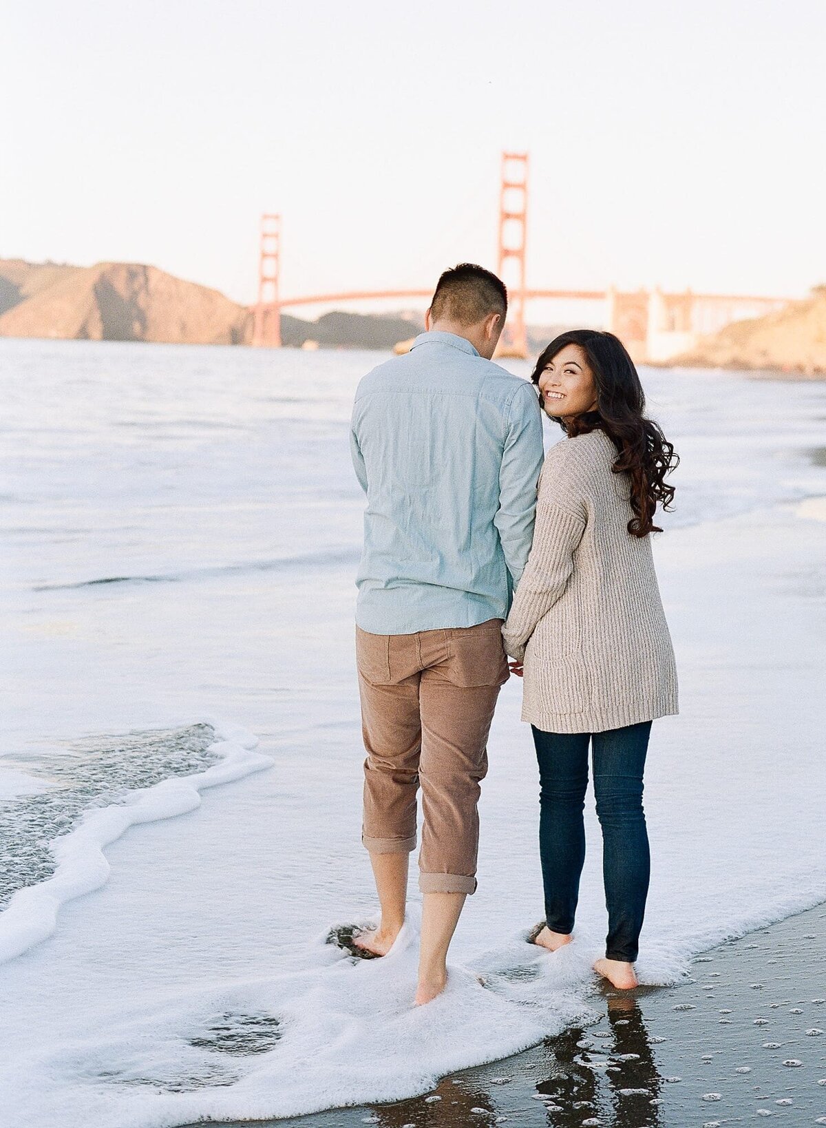 Engagement Photographer in San Francisco perfectly capsulates a lifetime memory of a romantic couple walking by the beach.