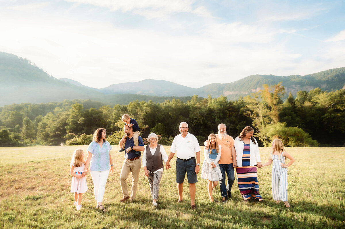 Family walks along together on a mountain top  during Family Photos in Asheville, NC.