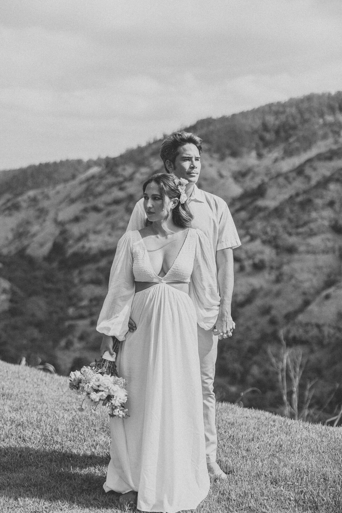 Bride and groom standing together serious