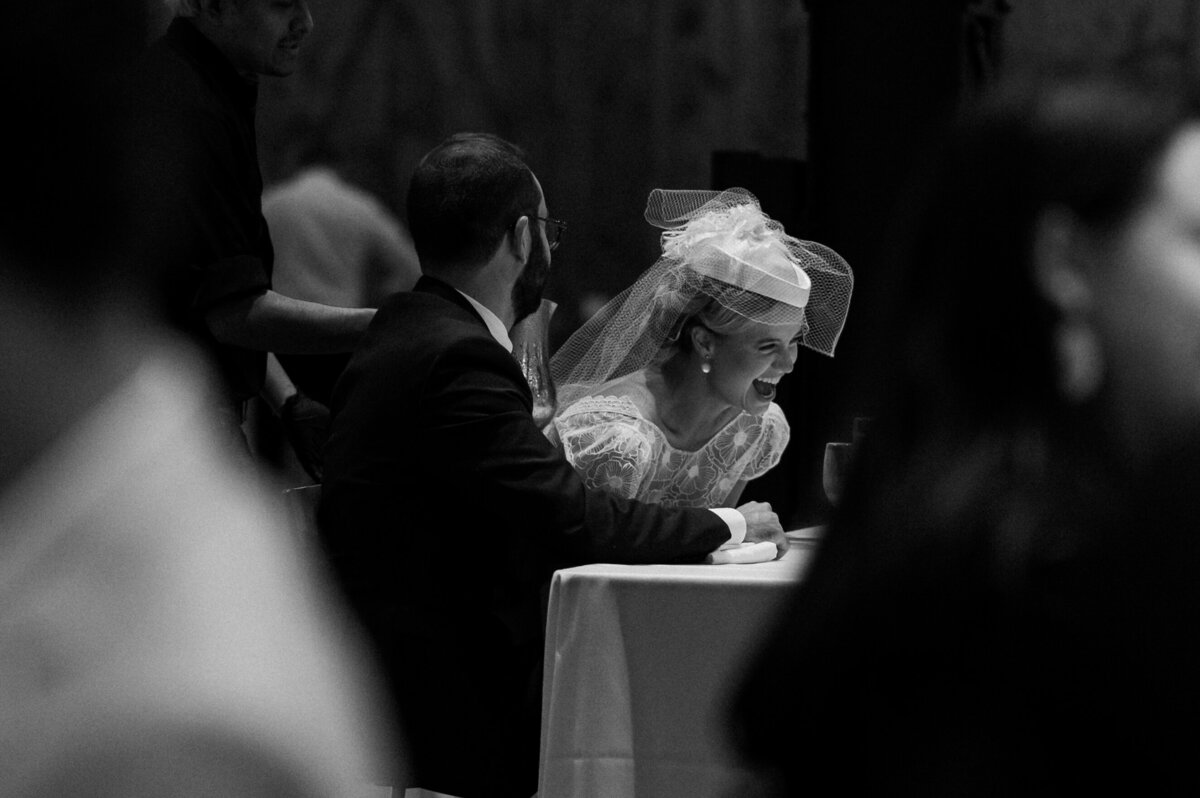 couple at their wedding reception laughing