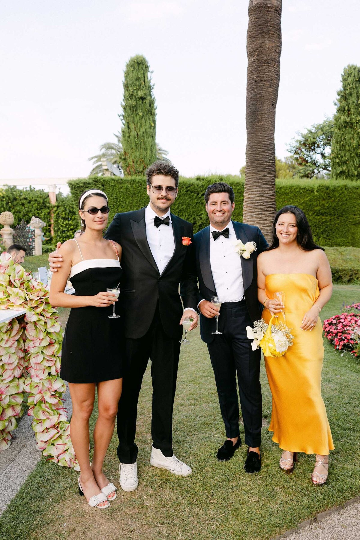 Guests having fun during the cocktail hour in the gardens of VIlla Ephrussi.