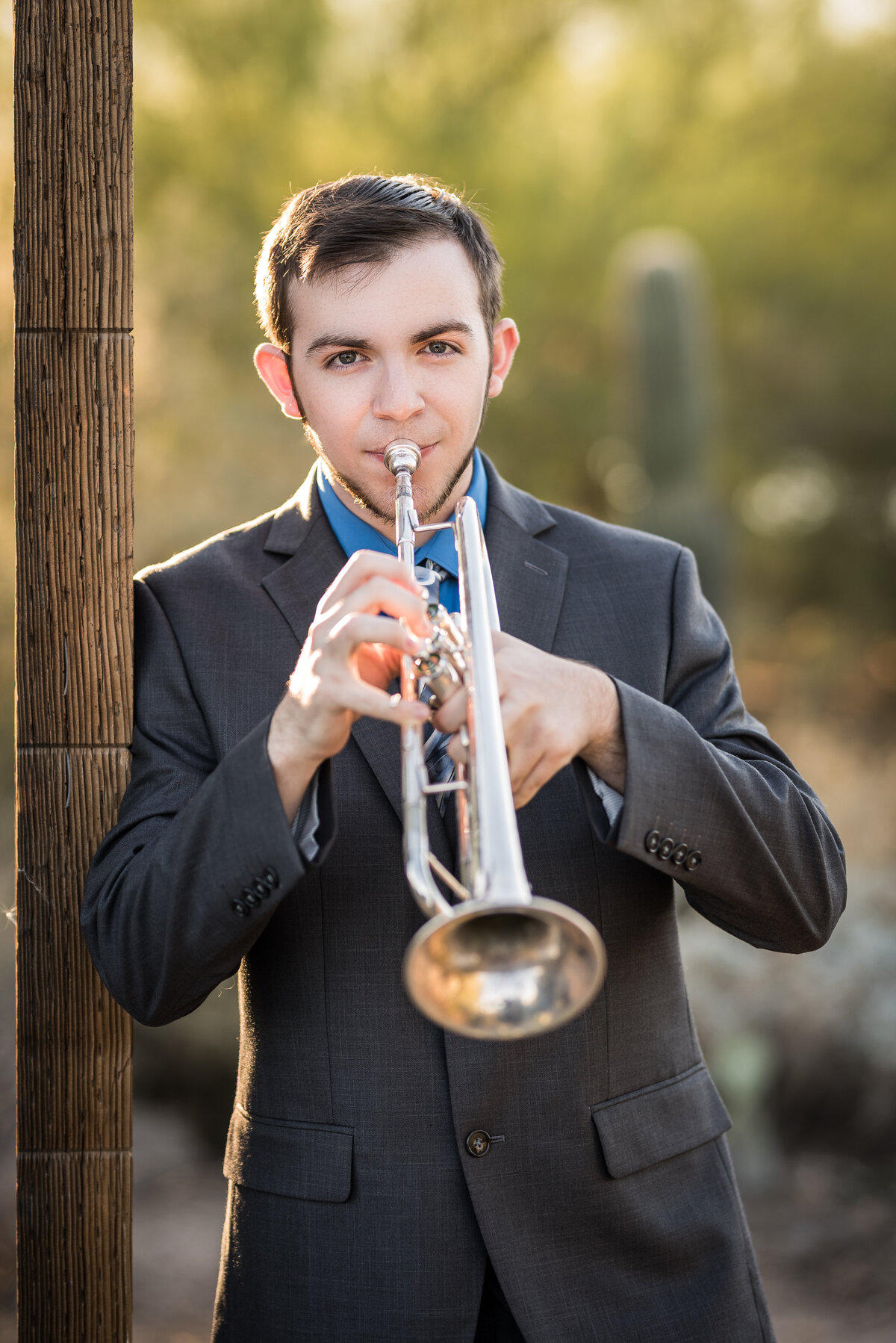 Senior guy wearing a suit and playing the trumpet
