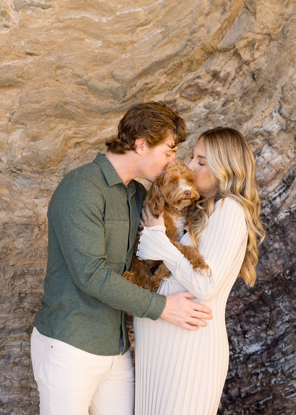 maternity photo with parents kissing dog