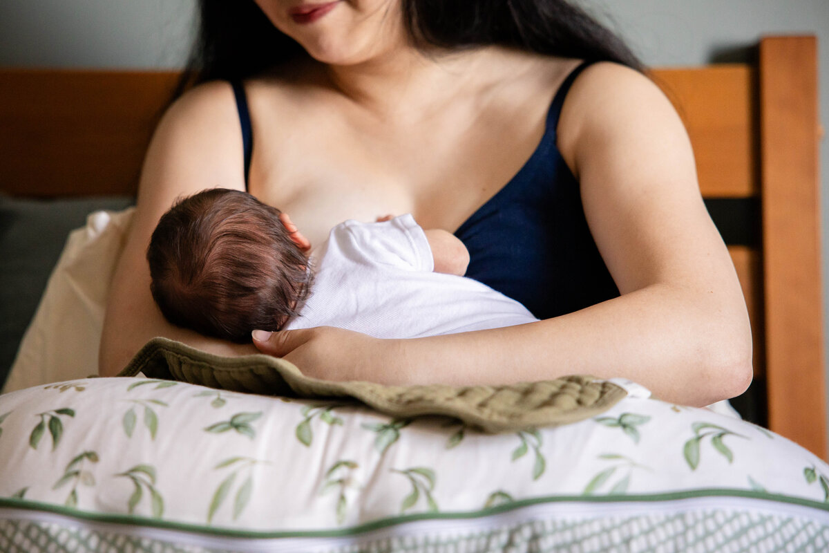 Mother nursing newborn baby girl