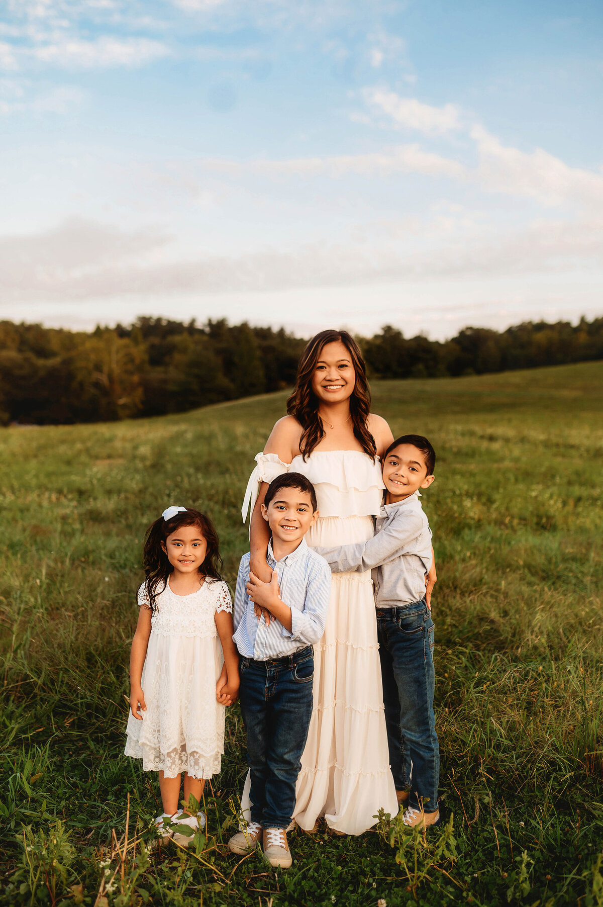 Mother embraces her children during Family Photos at Biltmore Estate in Asheville, NC.