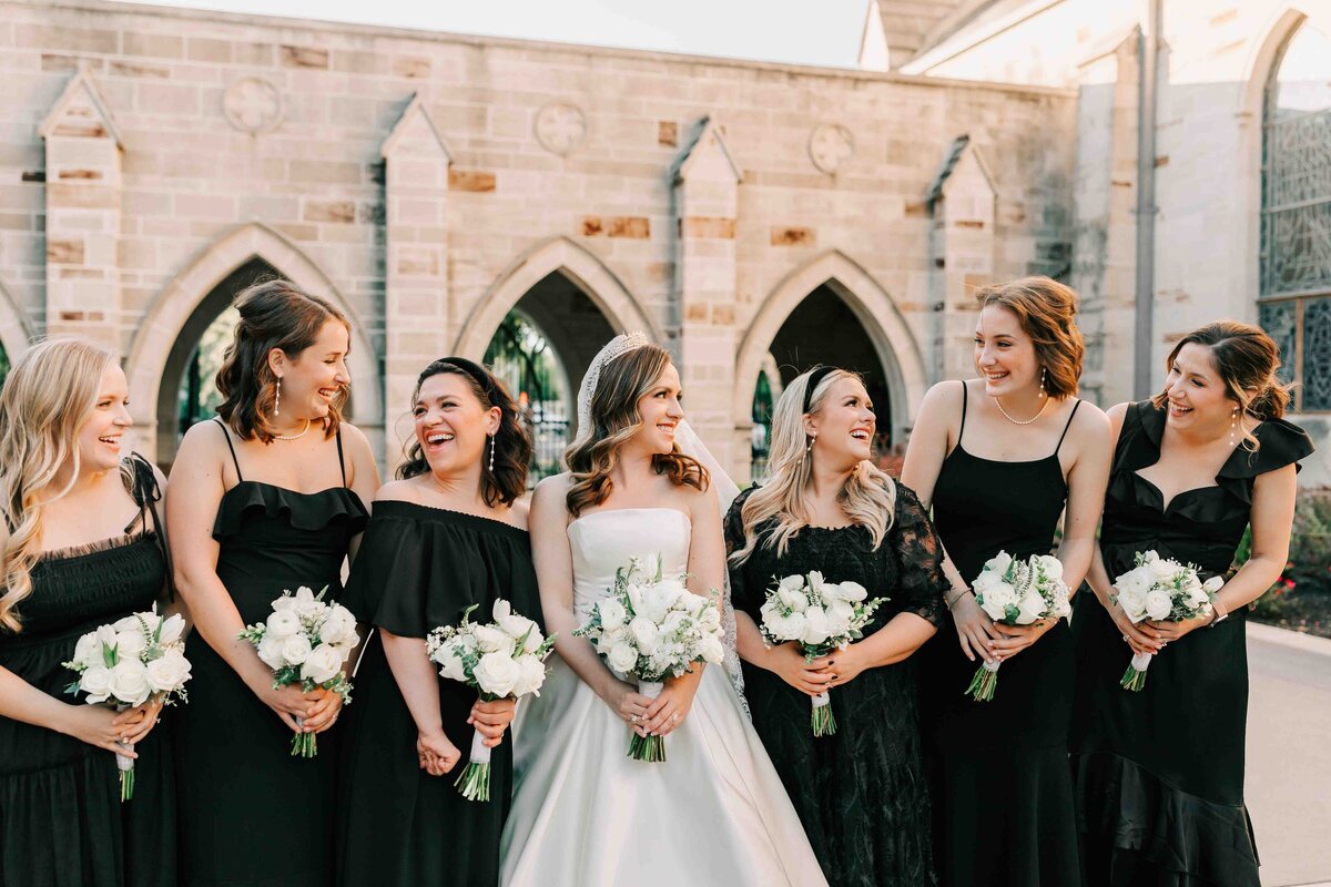 brides wedding party dressed in black at gorgeous chapel in Houston