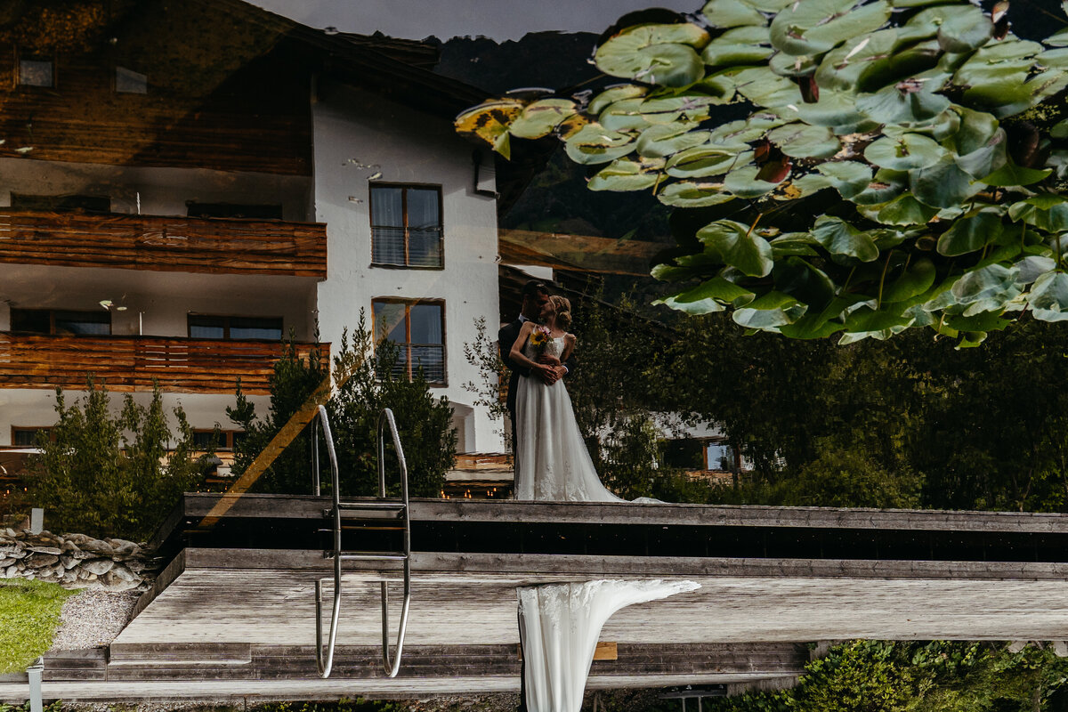 Wedding ceremony setup reflected in natural pond