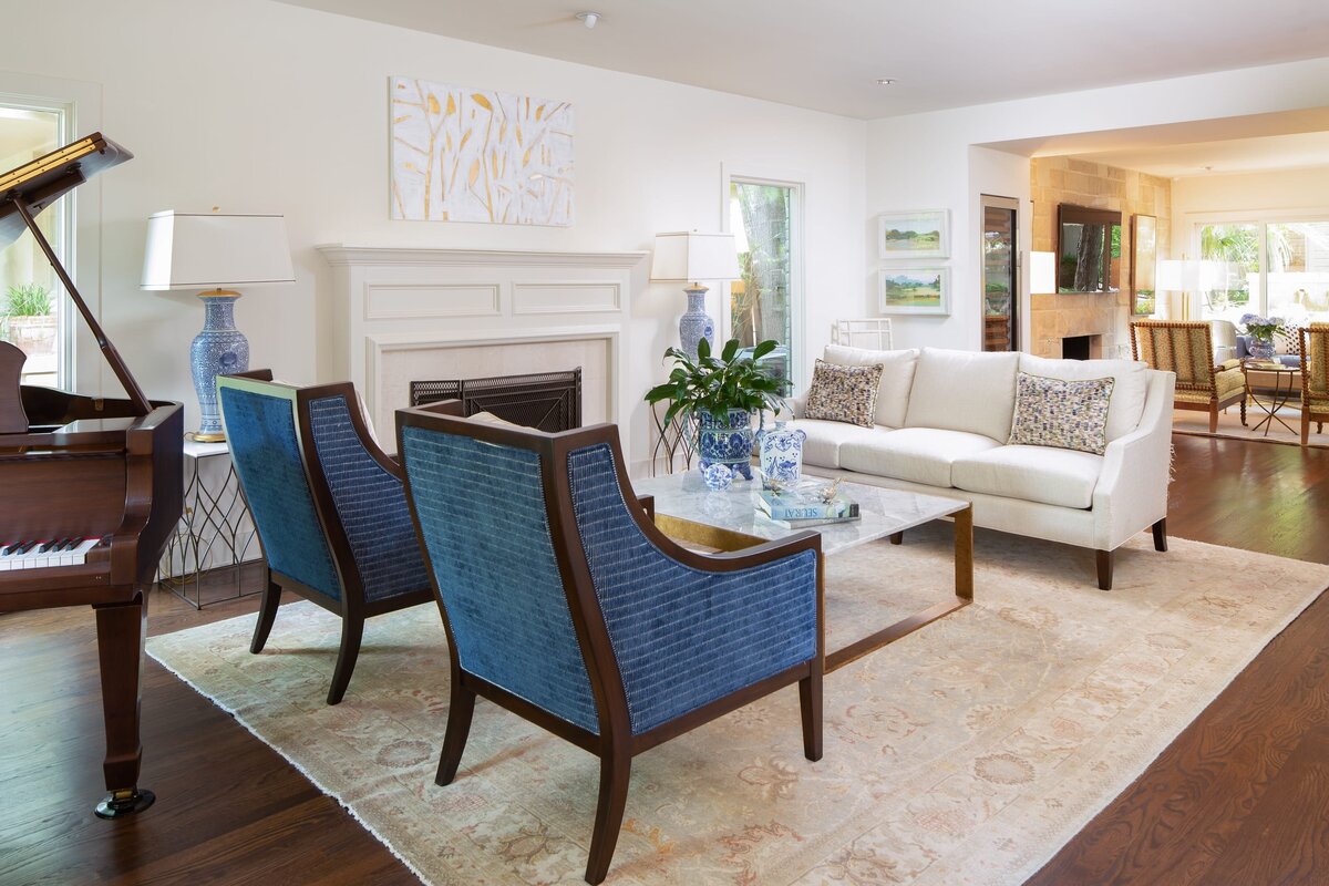 the keeping room interiors grant sitting room with blue chairs and marble coffee table