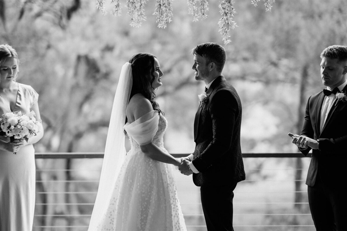 A couple stands lovingly together at the ceremony, radiating happiness and anticipation.