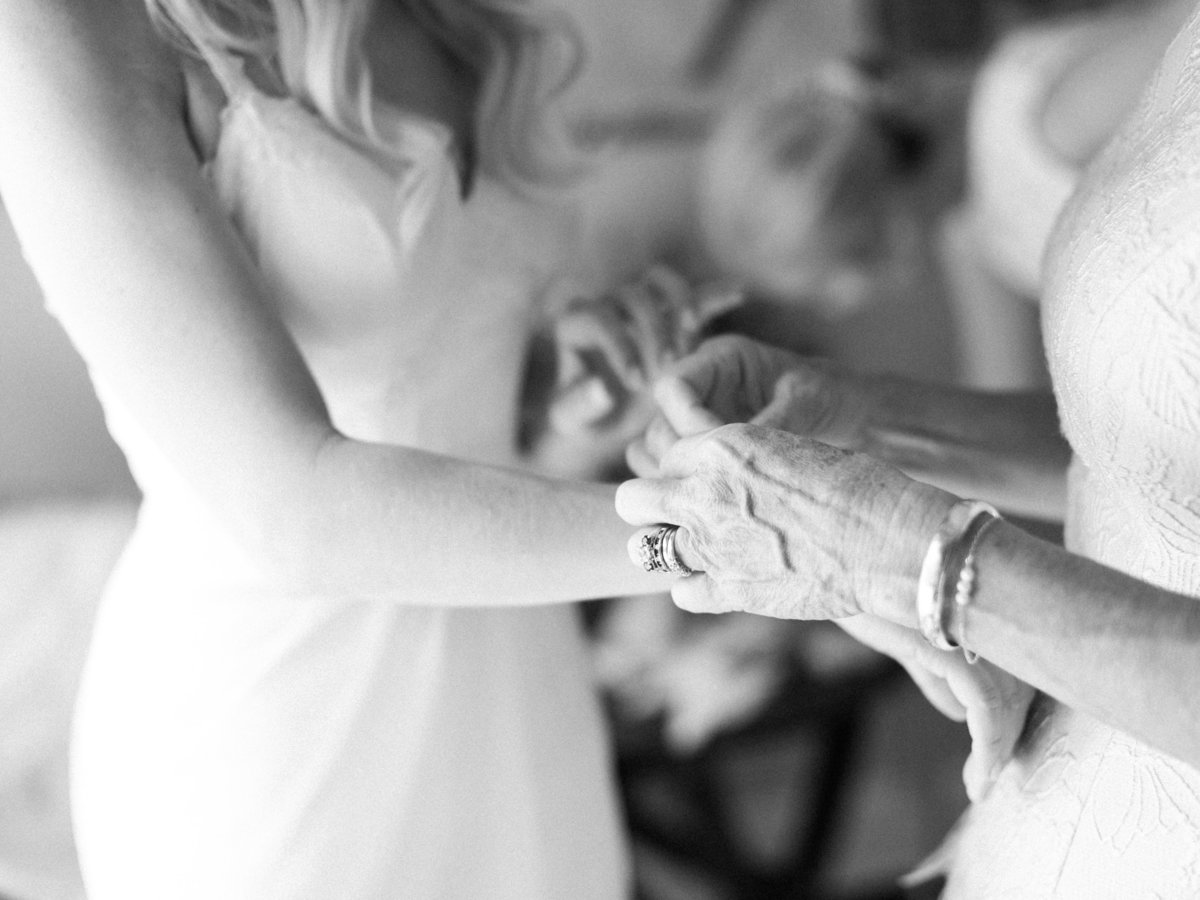 mother of the bride putting on a bracelet