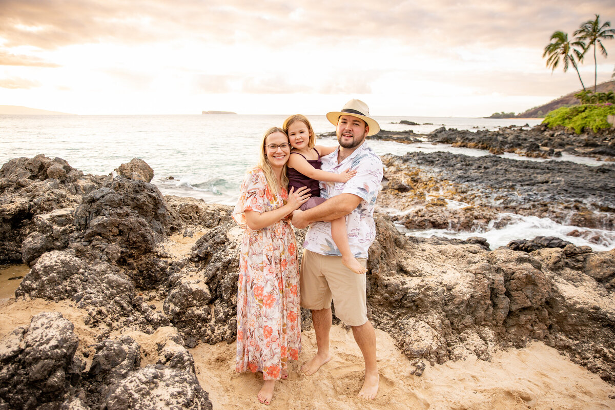 Maui Family Photographers capture father holding child while mother hugs them both