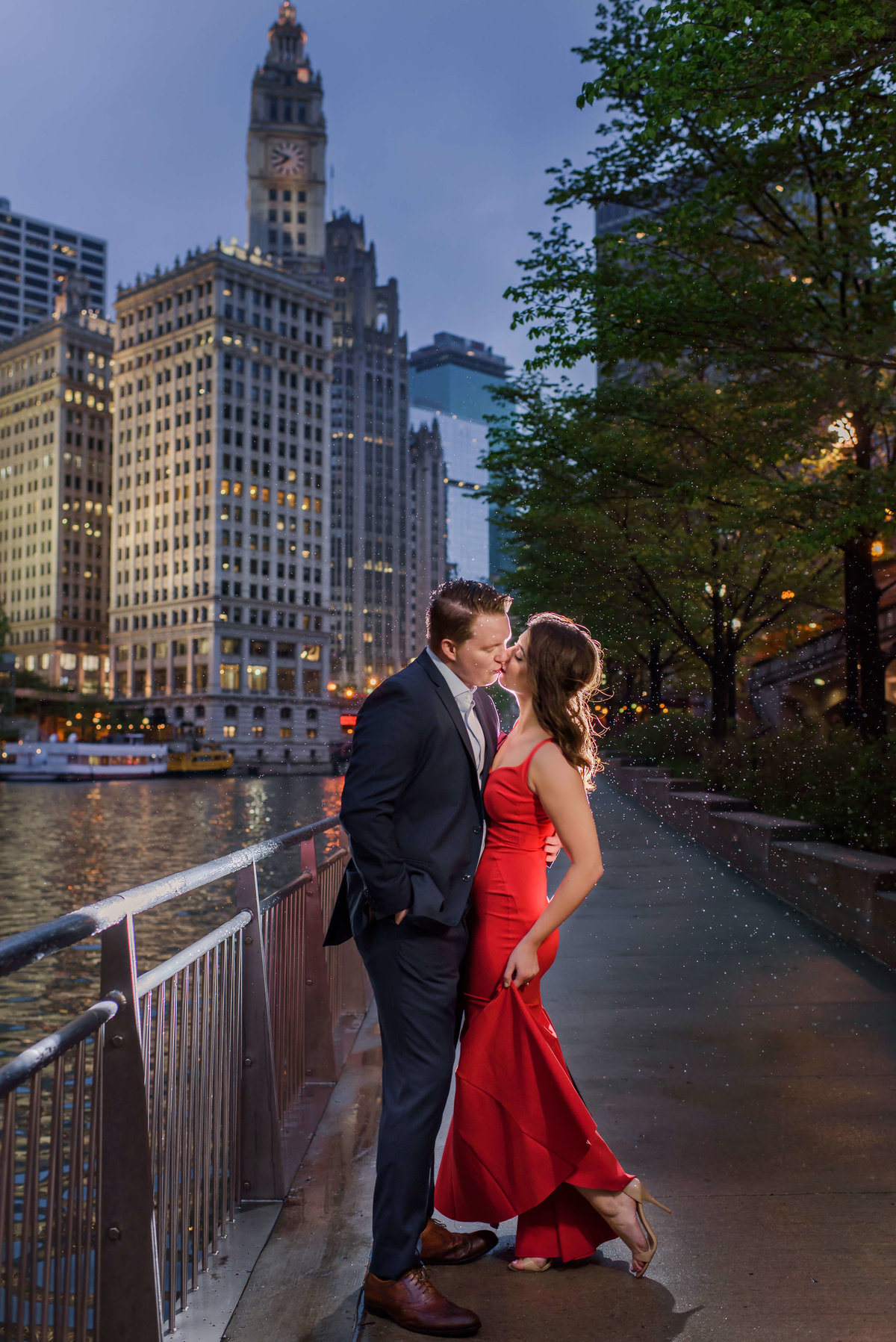 Stunning photo of a couple kissing surrounded by the lights and buildings of Downtown Chicago
