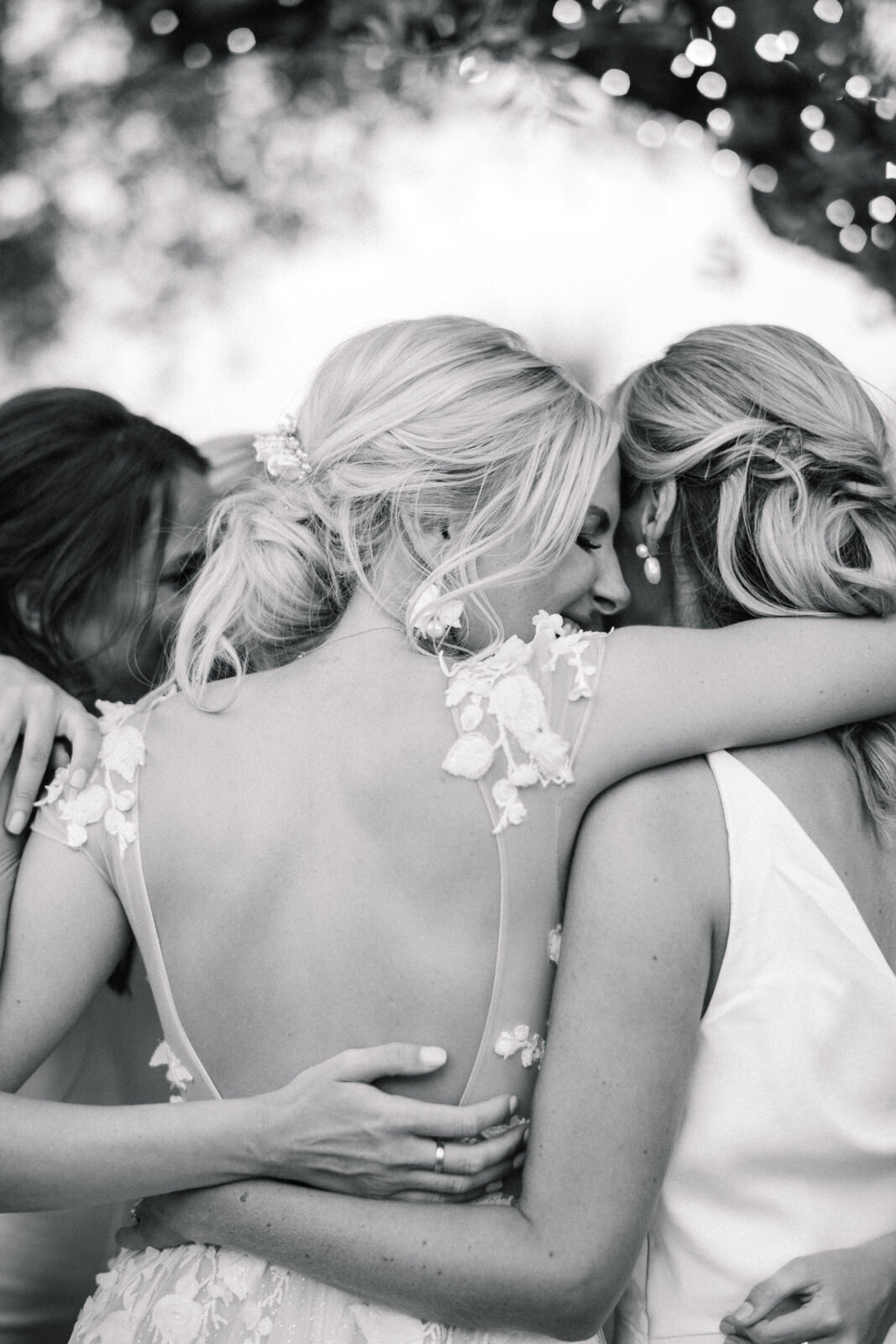 bride hugging bridesmaids at wedding in mallorca