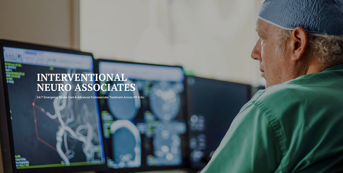 Doctor reviewing brain scans on monitors at Interventional Neuro Associates, professional medical branding photo by Alex Kaplan Photography in New Jersey.