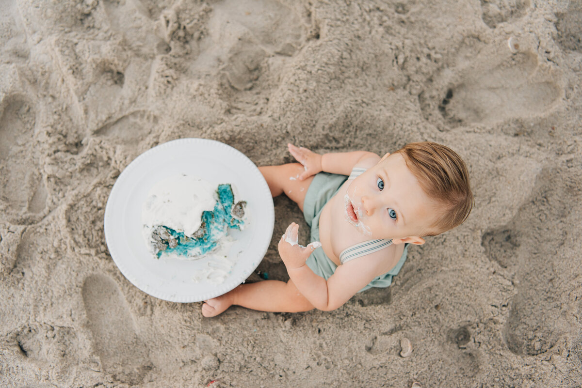 Overhead shot of one-year old boy smiling up at the camera