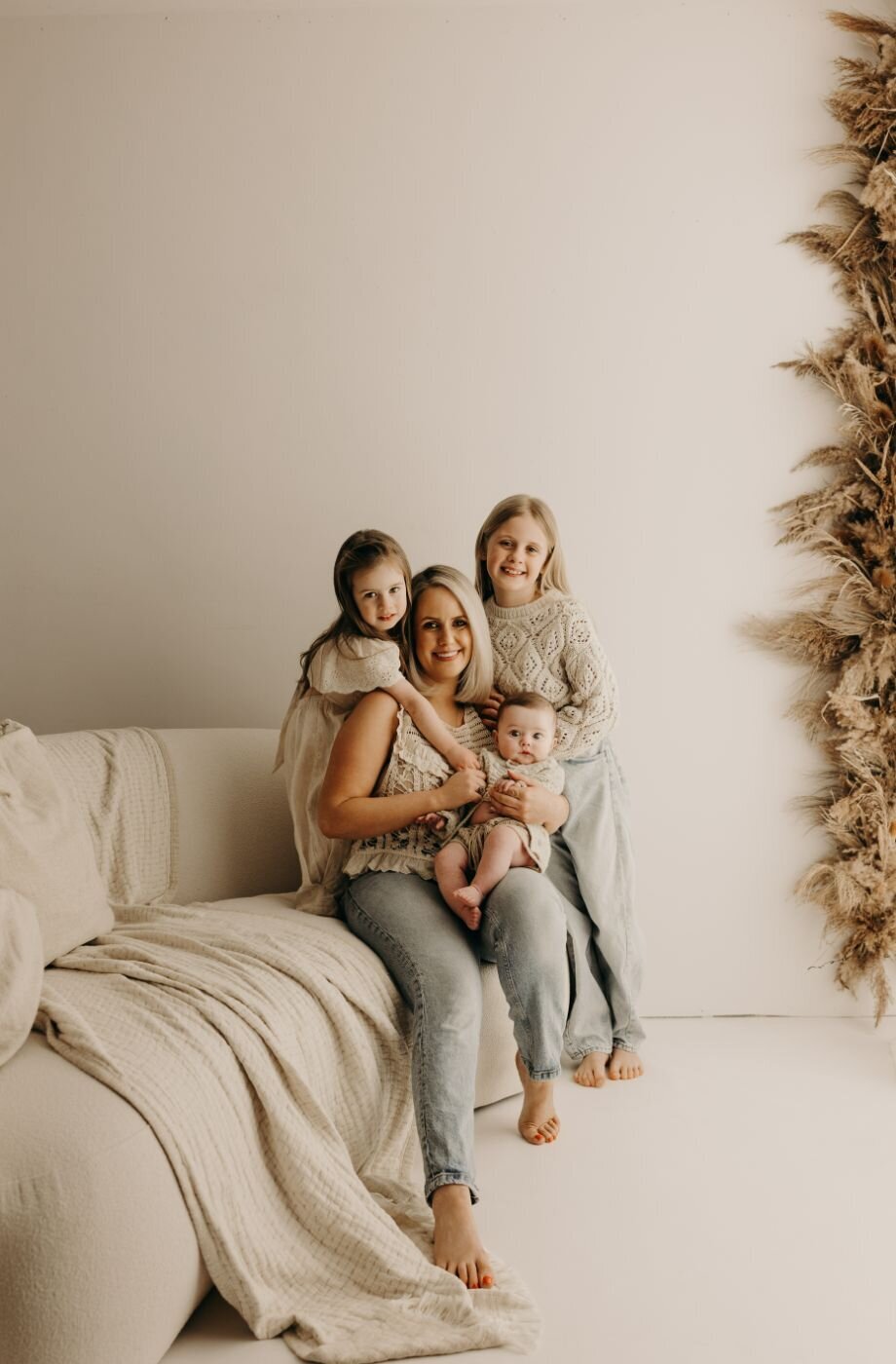 Mother with her three children (baby, toddler, and young girl) in a cozy family portrait in Mullingar, Ireland