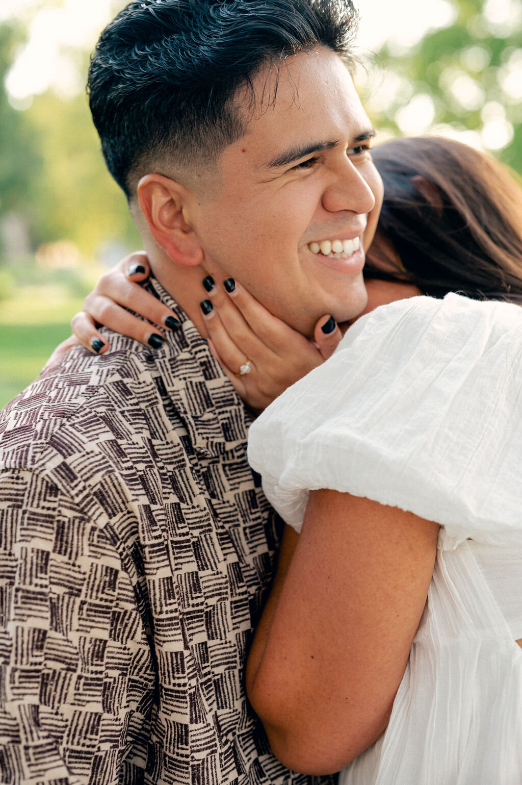 Candid engagement photos in Denver at Washington Park.