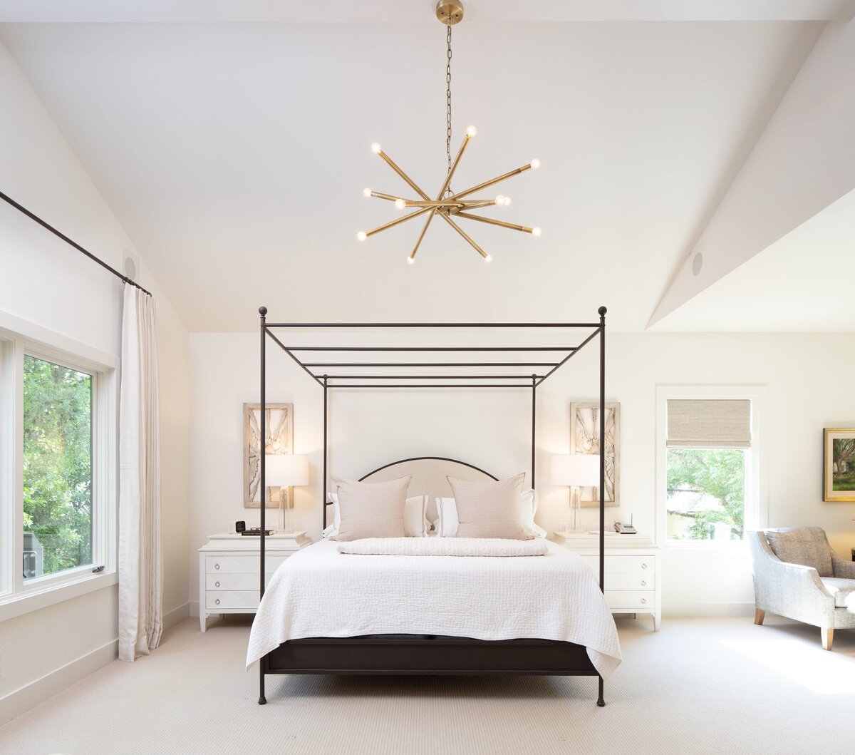the keeping room interiors grant bedroom with black canope bedframe and gold light fixture
