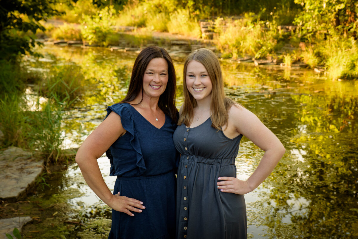 Mother and daughter portrait standing with their arms around each other near the creek at Fonferek Glen County Park near Green Bay, Wisconsin