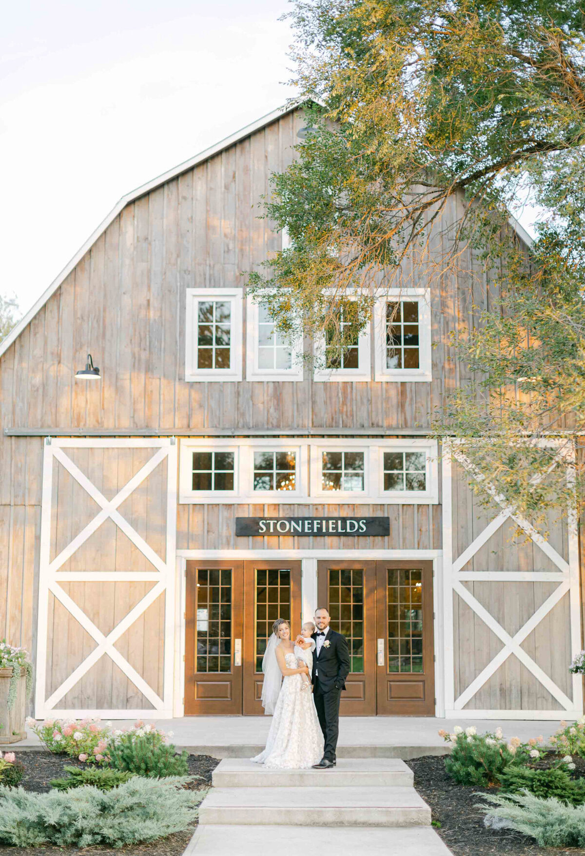 Couple in front of Stonefields captured by Megan Renee Photography, classic and romantic wedding photographer in Calgary, Alberta. Featured on the Bronte Bride Vendor Guide.