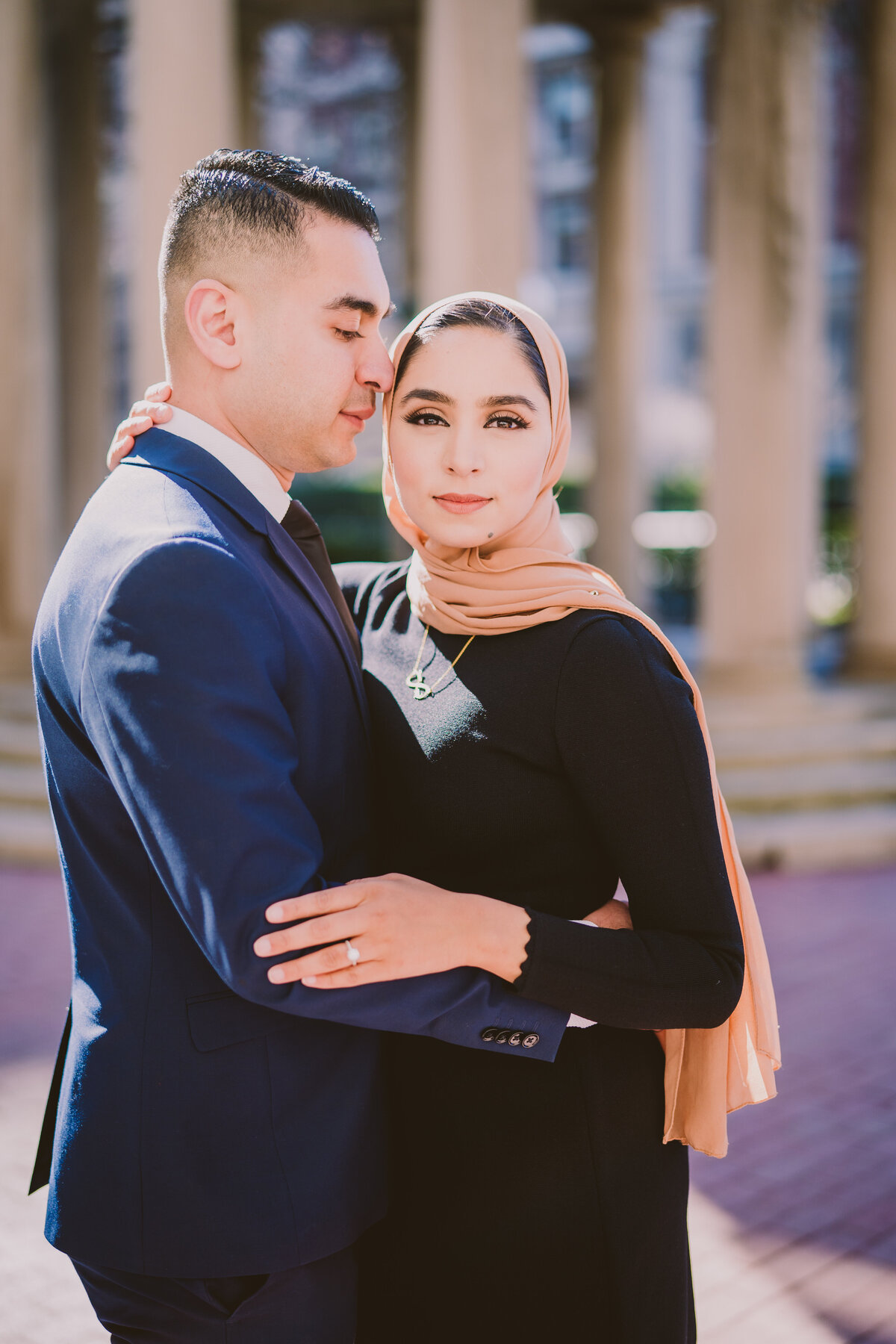 engaged muslim couple in formal clothing share a moment during their engagement session at columbia university in nyc