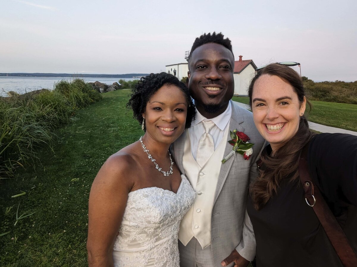 couple taking a selfie with photographer after elopement