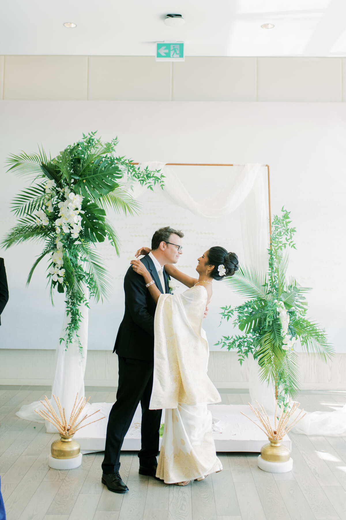 Bride and groom start to share a kiss at their wedding at the pearle hotel