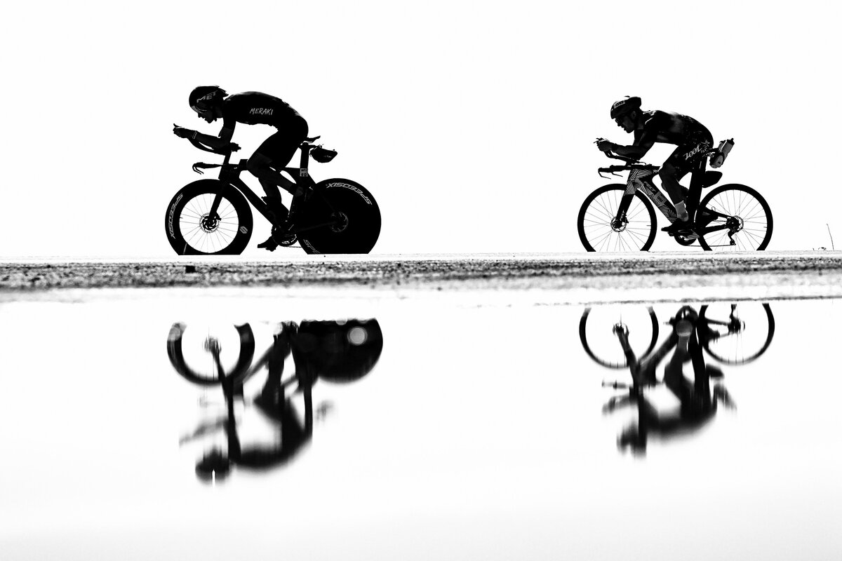 kansas-city-sports-photography-0167-black-and-white-photo-two-cyclists-reflected-in-water