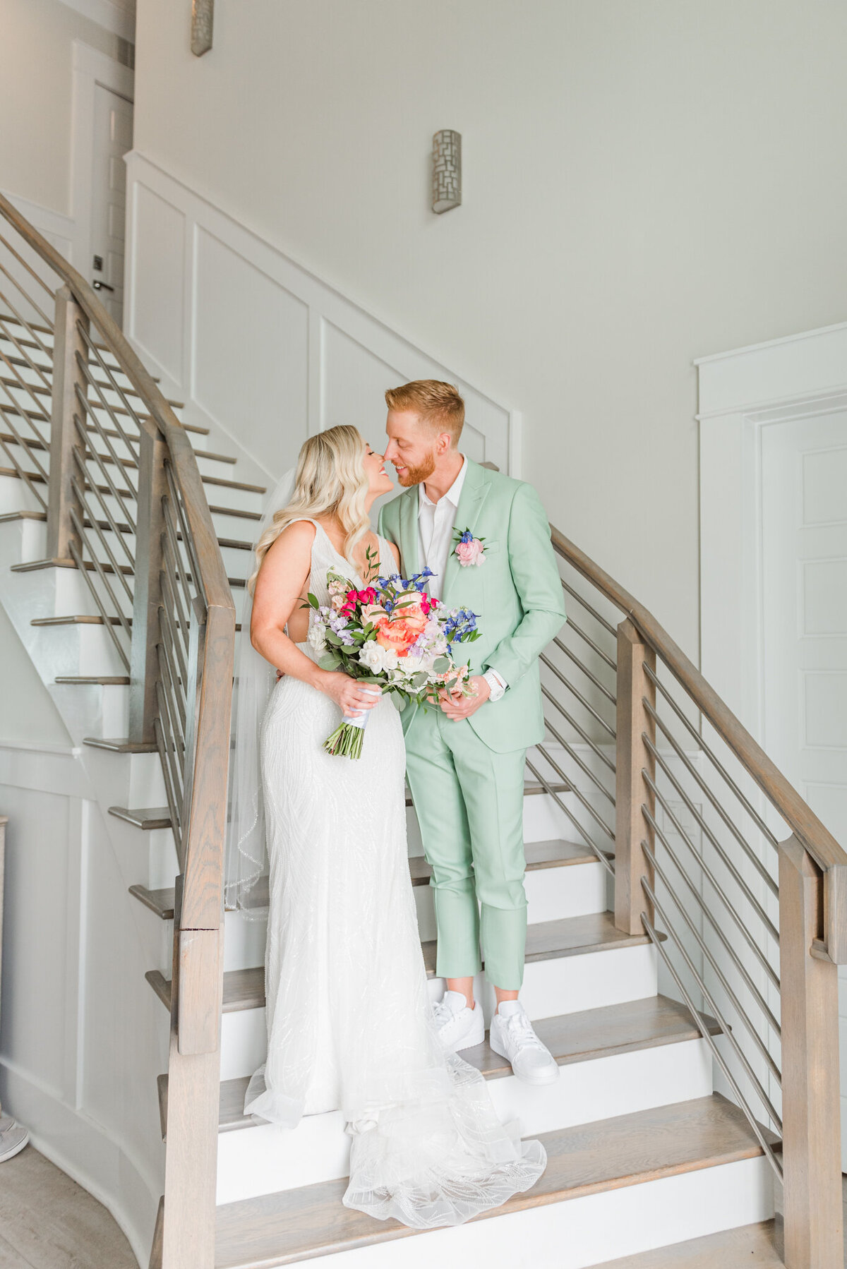 Bride and Groom kissing on stairs during their wedding in wrigthsville beach, nc