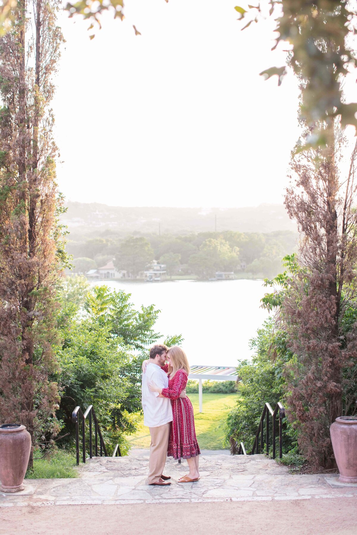 engagement session in Austin Texas on lake red dress sunset and tall trees by Firefly Photography