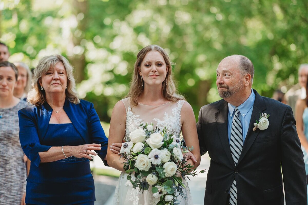 bride being escorted down the aisle