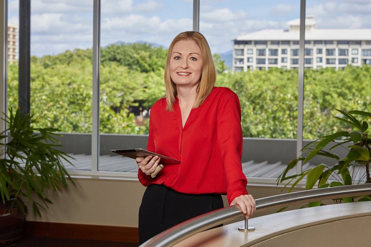 photo of business woman leaning on rail with iPad at the shangri la cairns