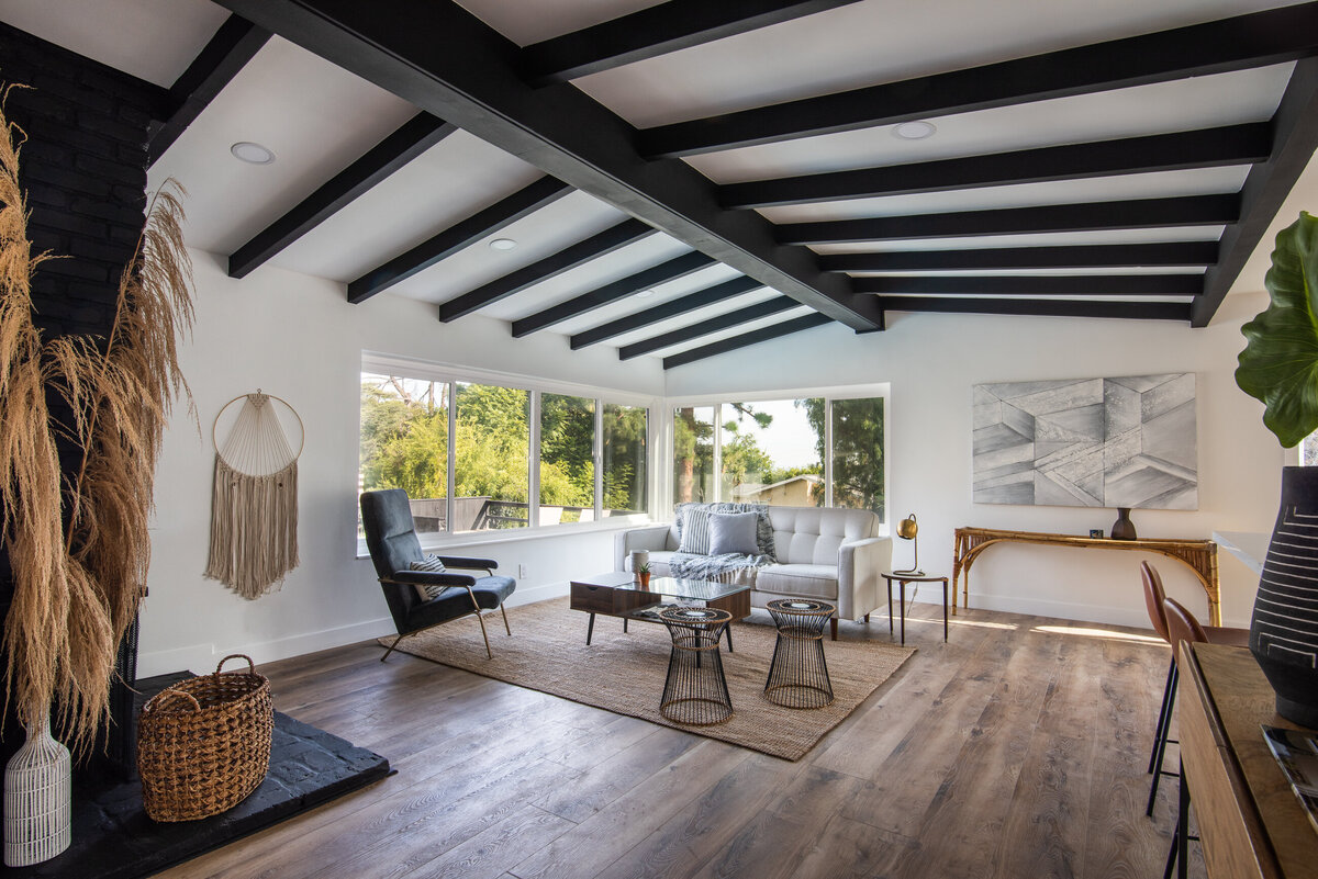 open-concept-living-room-black-beams-white-walls-aw-development