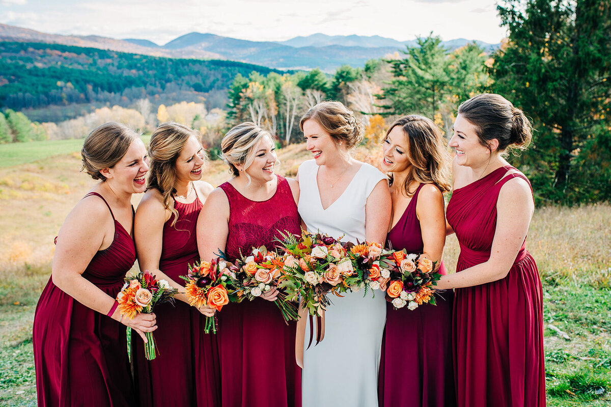 bride with bridesmaids in red dresses at lake bomoseen lodge and taproom