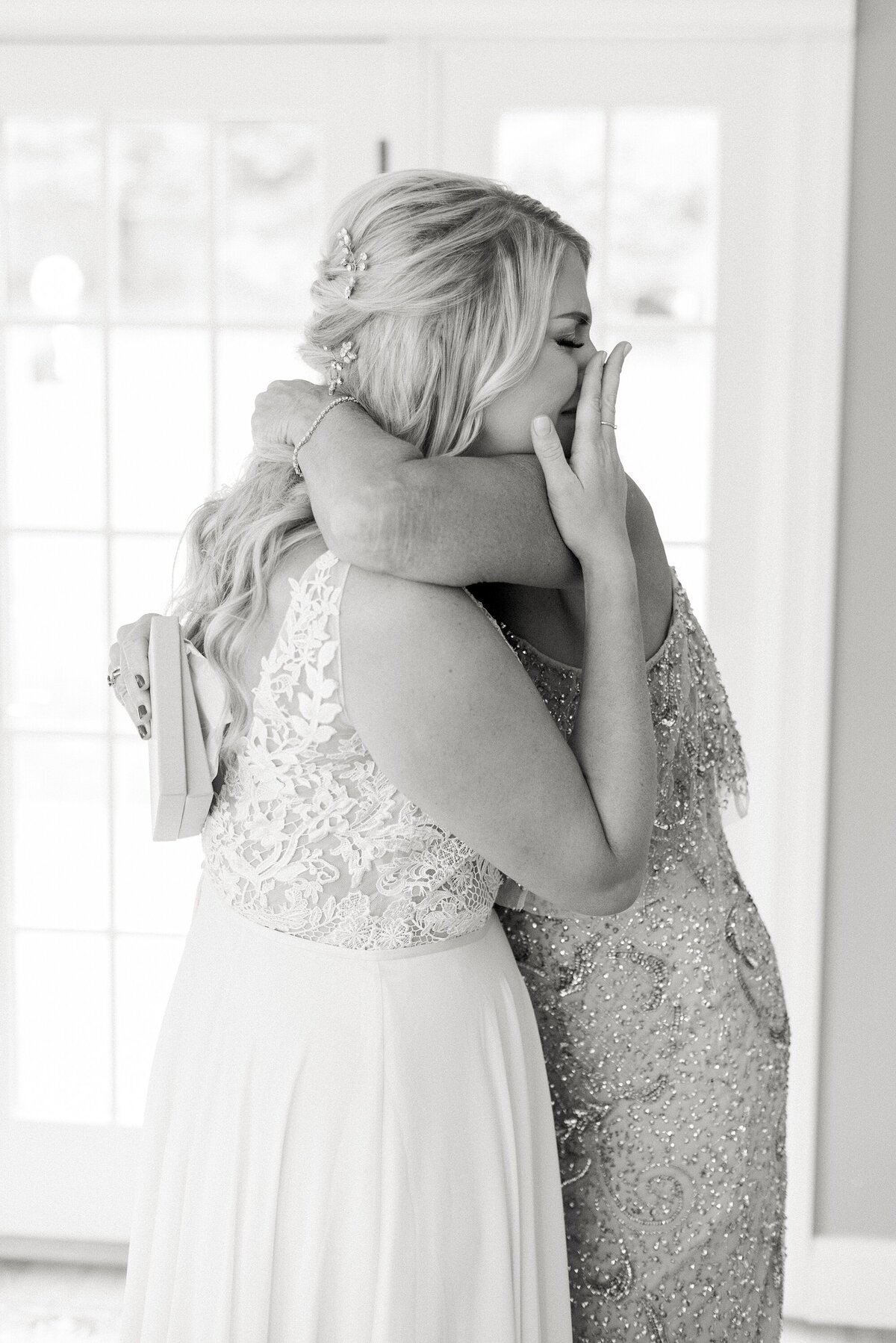 mother daughter bride embracing by nicole detone photography