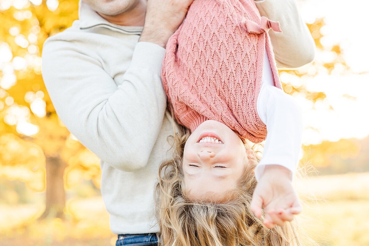 girl upside down during outdoor newborn photo session with Sara Sniderman Photography