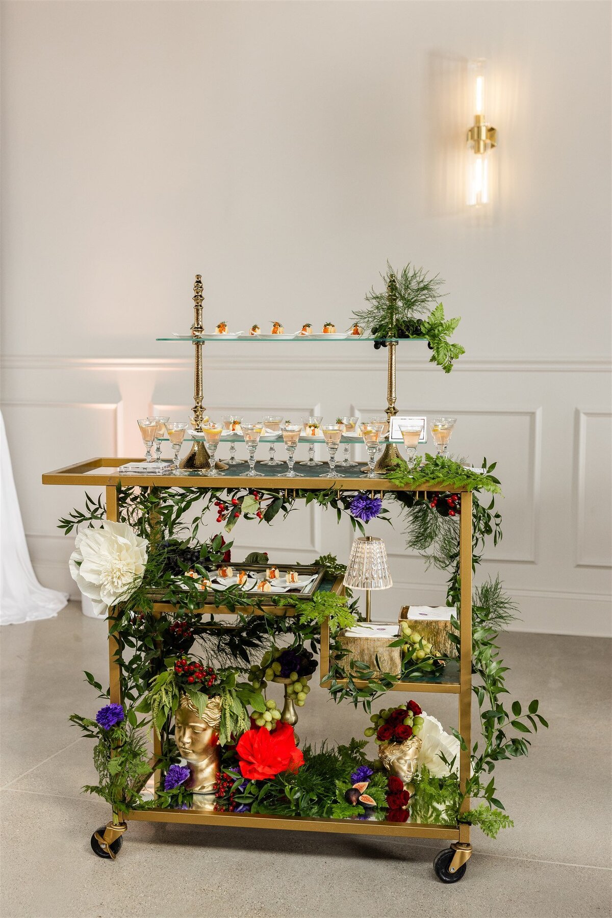 Venue space set up as an endive station, with neatly arranged endive leaves filled with gourmet toppings on elegant platters, displayed on a styled table with decorative accents