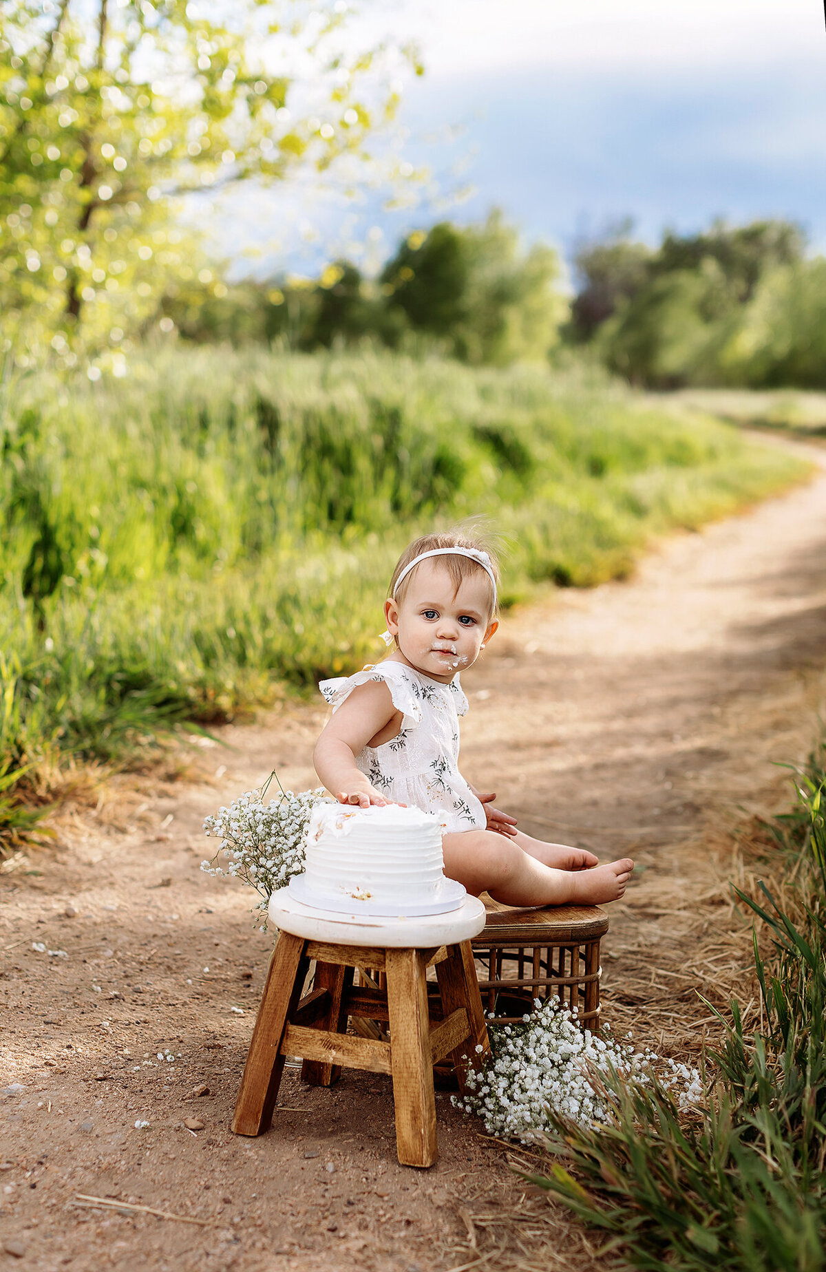 adorable floral set up for a cute baby girls cake smash ession in denver