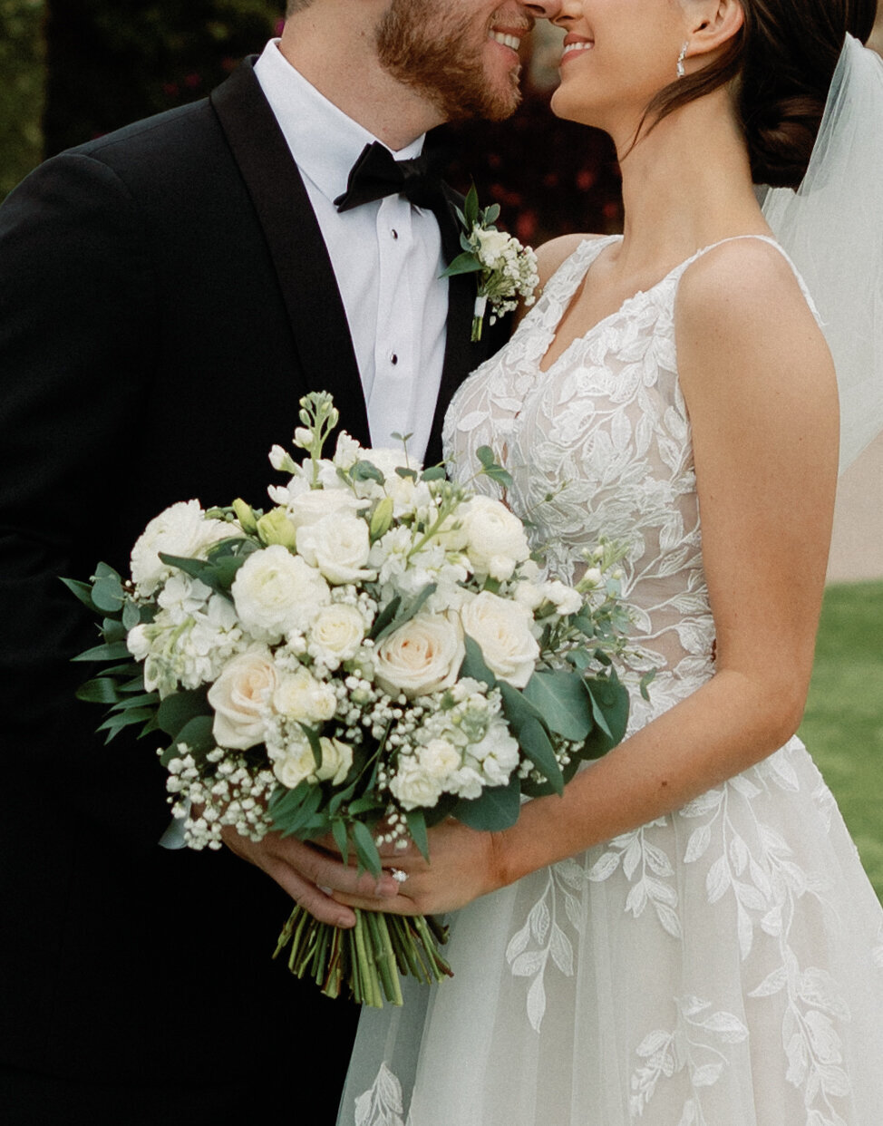 bride and groom holding bouquet at bella collina weddings & events​