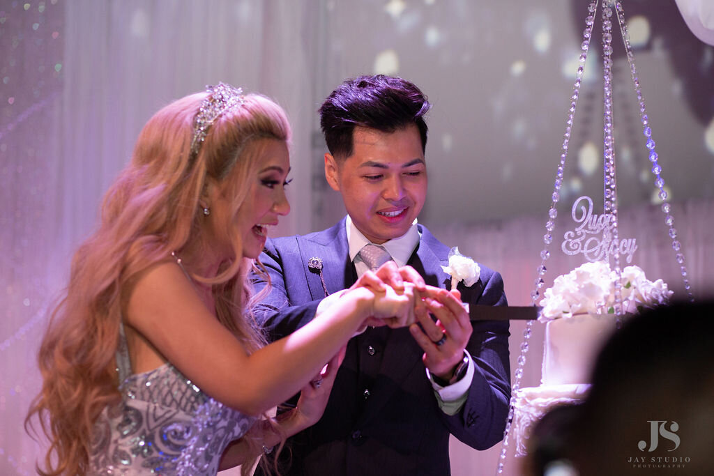 Bride and groom cut their wedding cake.