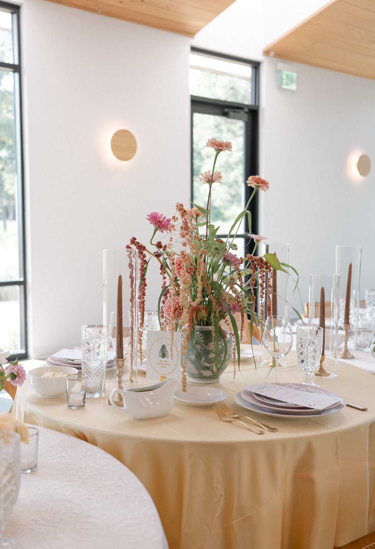 Colorful garden party wedding reception table with menu and table number with a handpainted watercolor butterfly and modern typography by Dear Margo Designs with flower arrangements by Lovelilly Floral for an Austin, Texas wedding at The Grand Lady venue