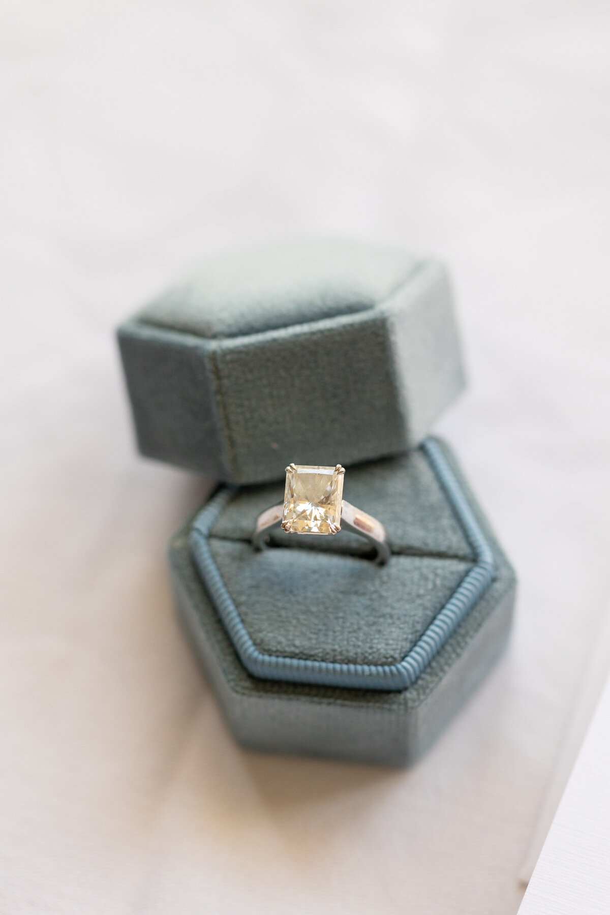 An engagement ring in a blue ring box