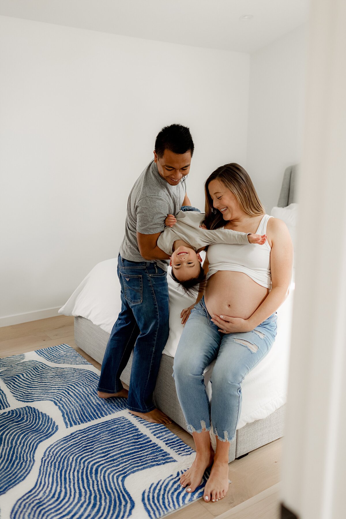 A maternity photography shoot in Boulder documents the baby bump in soft natural light flooding through the family’s home.